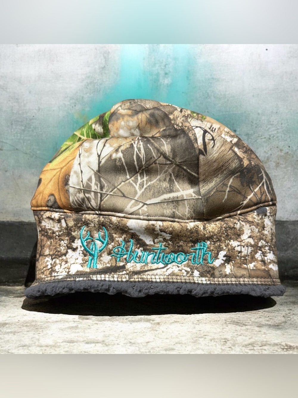 Huntworth Camo Quilted Beanie with Teal Embroidery and pony tail pocket on back.